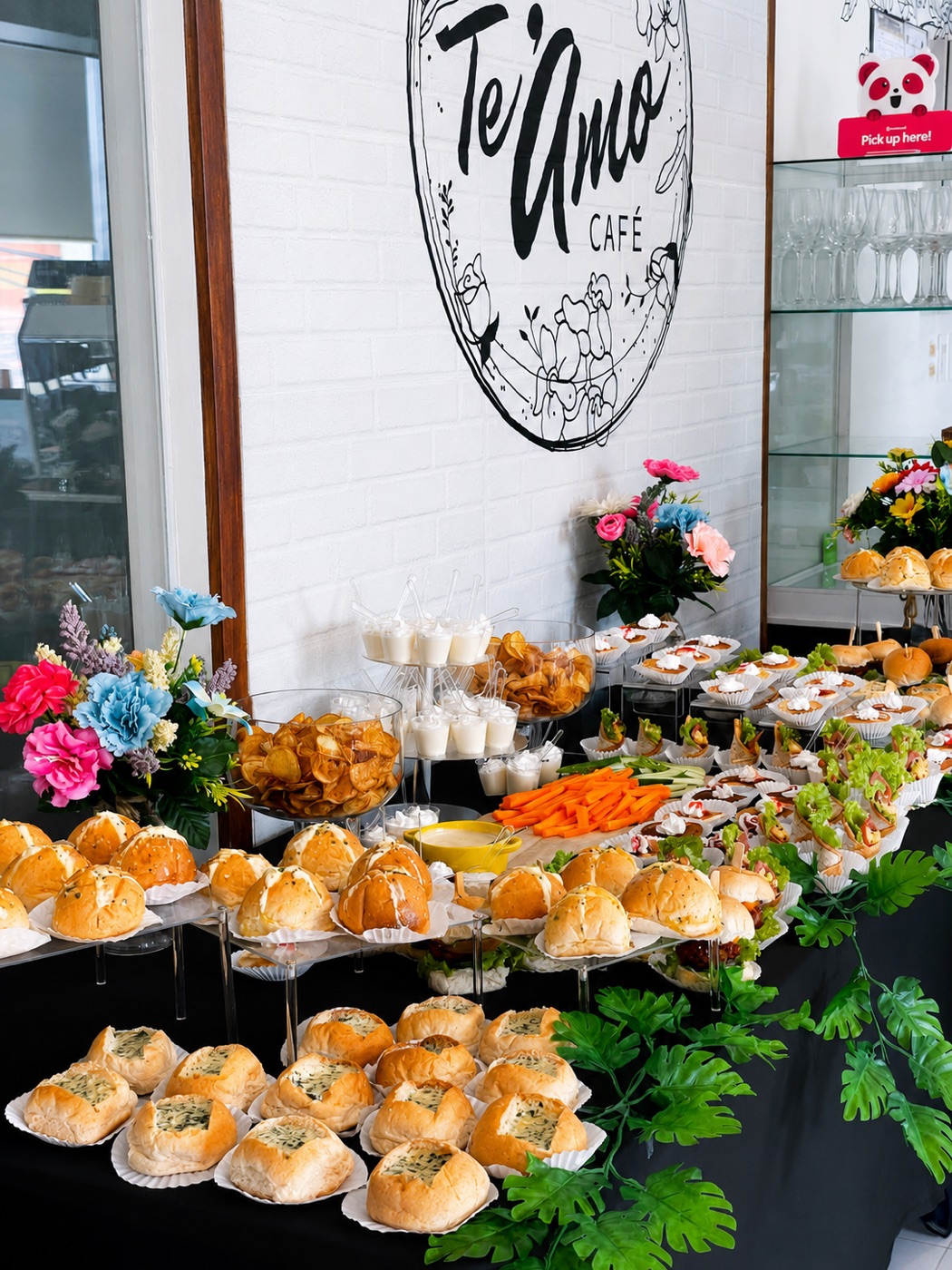 Grazing table spread under the Te'Amo logo wall