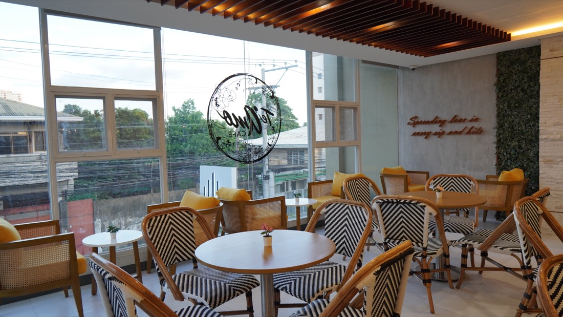 Inside Te'Amo Café, bright tables by the window